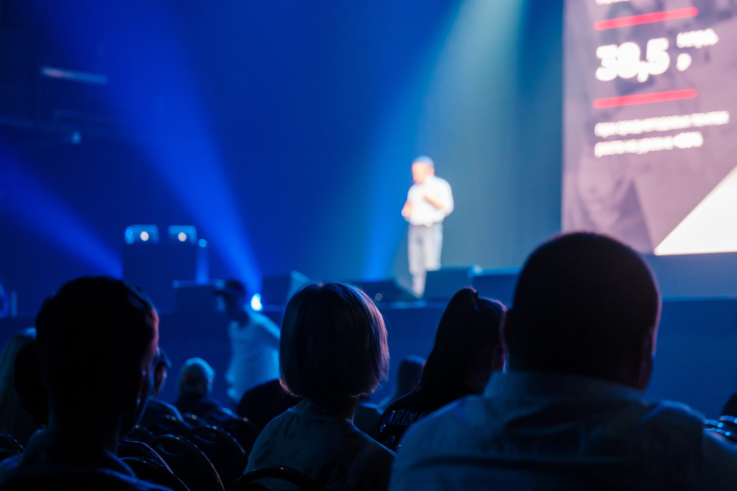Unrecognizable people listening to speaker during business conference